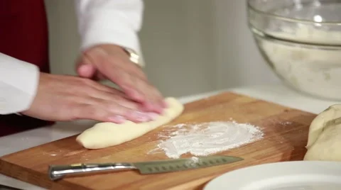 Man rolls dough with his hands Stock Footage 49783541