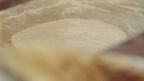 Man rolls dough with rolling pin for pita breads  in local Bulgarian restaurant Stock Footage 113950847