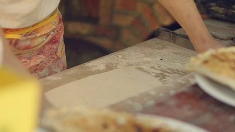 Man rolls dough with rolling pin for pita breads  in local Bulgarian restaurant Stock Footage 113950900