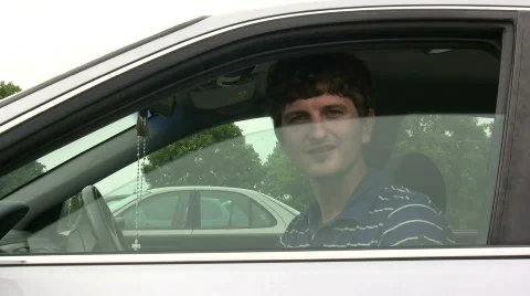 Man rolls down car window and waves 库存影片 557884