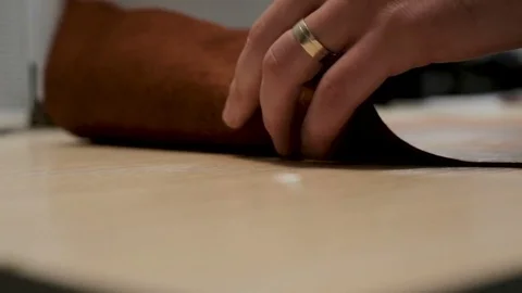 Man rolls a roll of leather 스톡 동영상 81985590