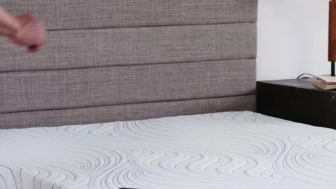 Man Rolls Up Weighted String After Mattress Sag Measurement Warranty Check Stock Footage 307823644