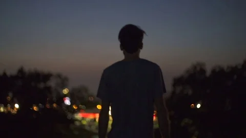 Man on Rooftop Looking at City Lights in Distance Slow Motion Stock Footage 81108466