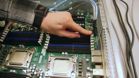 A man in a room for assembling server and computer equipment, adds parts, compon Stock-Footage 208296938