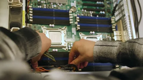 A man in a room for assembling server and computer equipment, adds parts, compon Stock-Footage 208297014