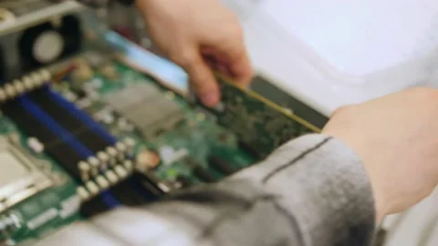 A man in a room for assembling server and computer equipment, adds parts, compon Stock-Footage 208297084