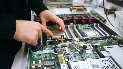 A man in a room for assembling server and computer equipment, adds parts, compon Stock-Footage 208297247