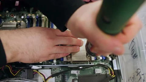 A man in a room for assembling server and computer equipment, adds parts, compon Stock Footage 208297267