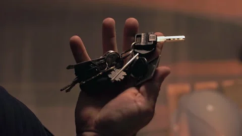 Man in the room pulls out a large bunch of keys from his pants pocket. Stock Footage 201891861