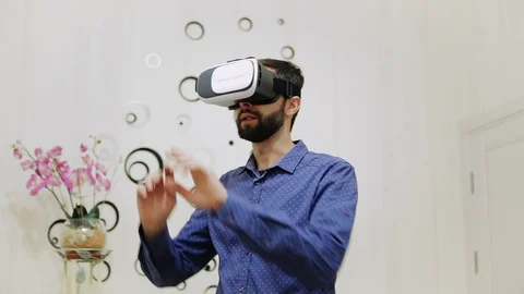 The Man In The Room Uses a Virtual Reality Helmet Stock Footage 73750484