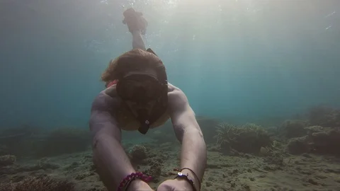 Man rotate underwater while Stock Footage 127840869