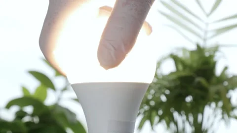 Man Rotates with His Hand a Led Bulb in ... | Stock Video | Pond5