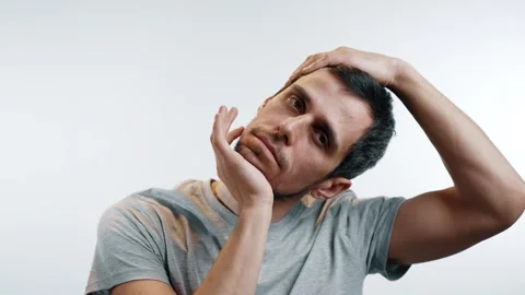 A man rotates his neck with hands Stock Footage 312474704