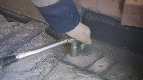 Man rotates tool fixing concrete part to floor close view Stock Footage 124892308