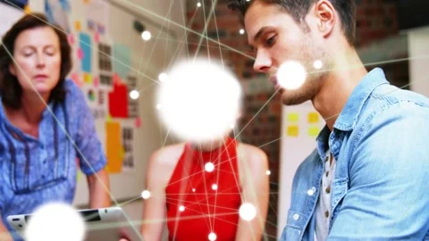 Man rotating and tapping tablet, sparking network nodes that bloom, flare, fade Stock Footage 333035138