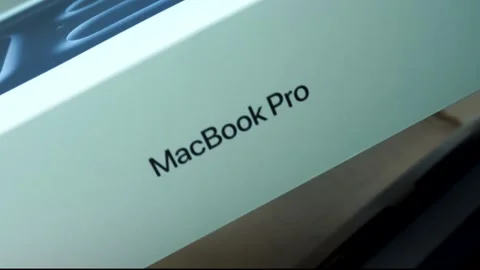Man Rotating Apple MacBook Pro 14 Inch Space Black Box During Unboxing Stockbeeldmateriaal 334643777