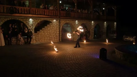 Man is rotating the fire staff around himself. Stock Footage 132251703