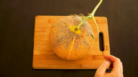 The man rotating melon in hands Stock Footage 113190889