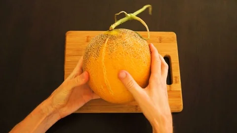 The man rotating melon in hands Stock Footage 113190915