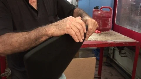 Man Rotating Plastical Piece in a Chair Factory Stock Footage