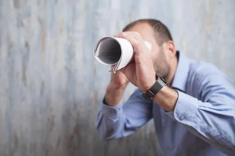 Man with a round document in office. Stock Photos