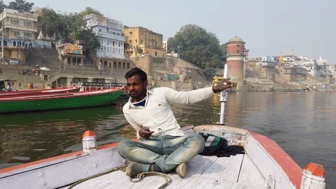 Man rowing boat on the Ganges Stock Footage 116546875