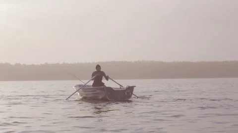 Man rowing on a calm lake Video stock 62757503
