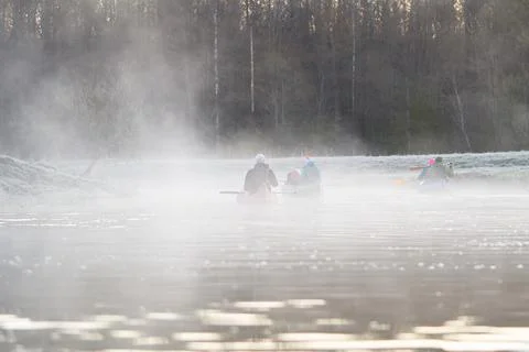 Man rowing a canoe in early spring in the early morning. lifestyle. Morning Stock Photos