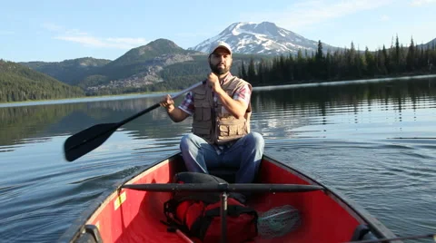 Man rowing a canoe Stock Footage 61669690