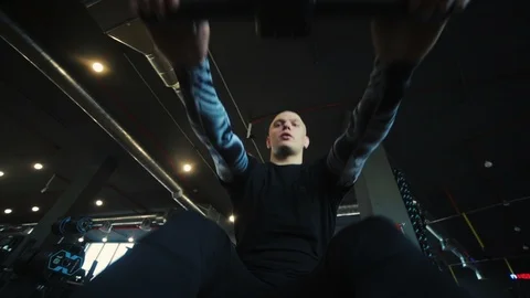 Man on rowing machine pulls oar and strengthens muscles Stock Footage 110575444