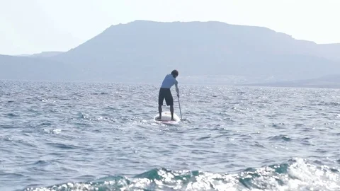 Man rowing on stand up paddle board Stock Footage 71060897