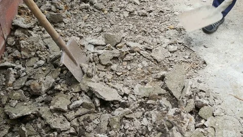 Man rowing the stones with a shovel Video stock 80279788