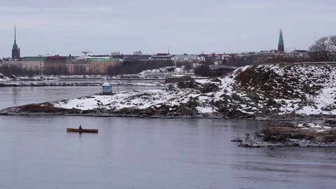 Man rows in the archipelago of Helsinki to a cliff where a other man is waiti Stock Footage 103343290