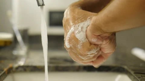 Man rub wet and soapy arms against carefully, then put hands under tap stream Stock Footage 164231884