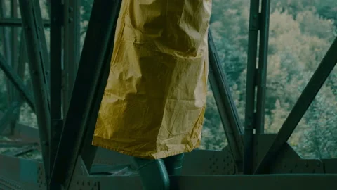 Man in rubber boots, protective suit, gas mask walks over an bridge. pandemic. Stock Footage 160365216
