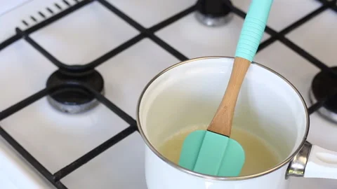 A man in rubber gloves makes syrup for zephyr. Includes thermometer to monito Stock Footage 135158778