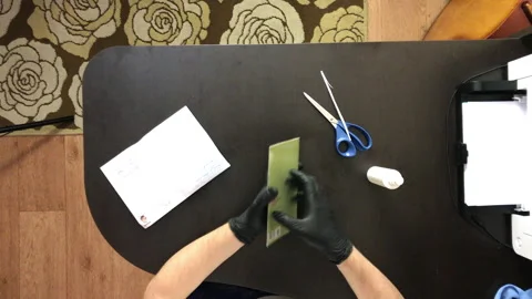 A man with rubber gloves. Opens the envelope and takes out a greeting card. F Stock Footage 144833356