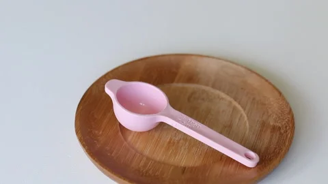 A man in rubber gloves pours agar agar into a measuring spoon. Making syrup f Stock Footage 135159093