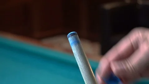 A man is rubbing a cue with chalk Stock Footage 95998273