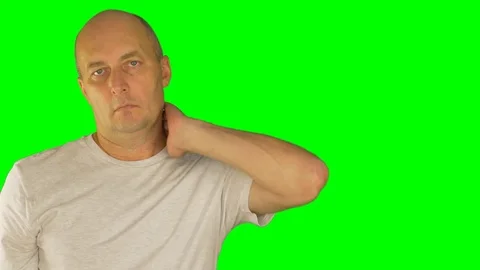 Man rubbing neck and shoulders with left hand. Close up front view. Locked shot. Stock Footage