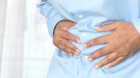 Man rubbing stomach while suffering from intense abdominal pain and gastroi.. Stock Footage 332745393