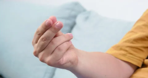 Man rubs ice cube between fingers limbering hand closeup Stock Footage 205166699