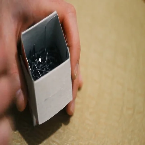 Man rummages in a small box with nails Stock Footage 69544273