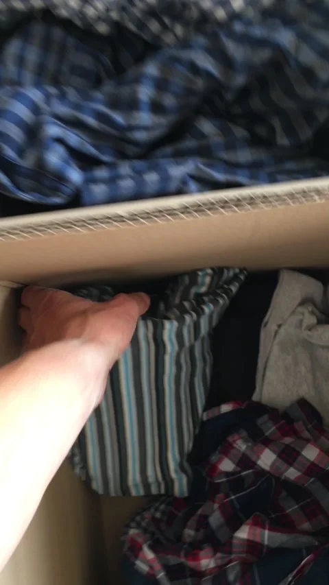 A man rummages through second-hand clothes. Fast fashion waste. Stock Footage 314710929