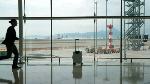 Man run and grab handle of forgotten trolley case, go away, silhouetted shot Video stock 144080402