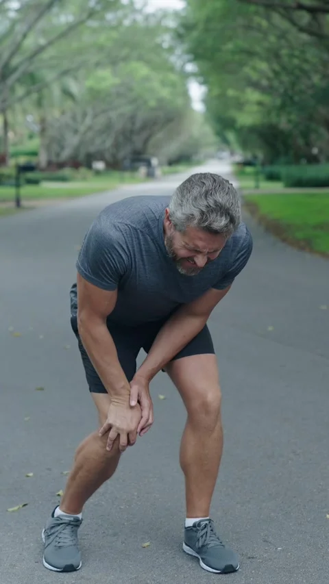 Man runner has knee pain. Knee joint dislocation after running. Sport injury Stock Footage 321914676