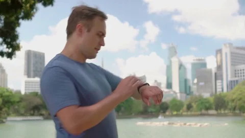 Man runner jogging in park. Fit male sport fitness running training. Dictating Video stock 74314918