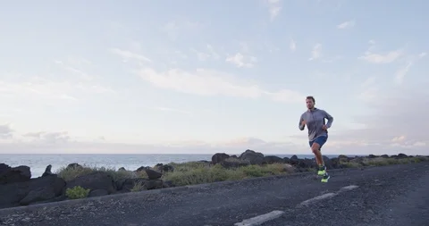 Man runner running on road at in slow motion. Stock Footage 122256558