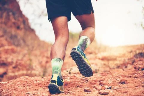 A man Runner of Trail . and Close up of an athlete's feet wearing sports sh.. Stock Photos
