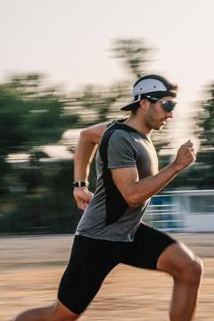 Man runner training on track in motion blur Stock Photos
